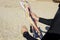 Close up a man hands rolling a kite bar and lines on the beach after kitesurfing. Kitesurfing equipment for kite courses. Extreme