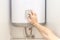 Close-up of man hands setting the temperature of water in Electric Boiler.