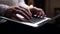 Close-up of man hands is working typing use laptop computer at dark home office, on knees.