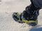 Close up of a man hiking on a mountain covered on snow, in boots with shoe skpikes. Outdoor winter trekking