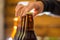 Close up of a man holding bottles of craft beer on blurred background