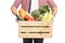 Close-up on man holding a crate full of vegetables