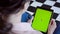 Close-up of man holding tablet and touching green screen. Stock fooatge. Young freelancer uses tablet to work or create