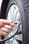 Close Up Of Man Inflating Car Tyre With Air Pressure Line