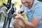 close up man inflating wheel bicycle