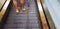 Close up man leg using and standing on flat escalator walkway with copy space