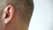 Close up man moving ear. Male left ear profile view. Human hearing organs. Human body part. Head anatomy.