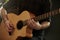 Close Up Of Man Playing Acoustic Guitar In Studio