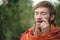 Close up a man playing on jaw harps, khomuses, folk musical instruments, selective focus