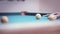 close up of a man plays billiards in the evening, hits a billiard ball
