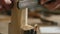 Close-up. a man processes a piece of wood with a file. the sound of carpentry tools. work with hand carpentry tools. art of