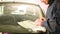 Close-up of a man professionally in the workshop engaged in eliminating cracks on the windshield of the car. Filling the