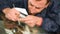 Close-up of a man professionally in the workshop engaged in eliminating cracks on the windshield of the car. Filling the