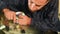 Close-up of a man professionally in the workshop engaged in eliminating cracks on the windshield of the car. Filling the