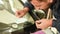 Close-up of a man professionally in the workshop engaged in eliminating cracks on the windshield of the car. Filling the