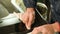 Close-up of a man professionally in the workshop engaged in eliminating cracks on the windshield of the car. Filling the