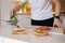 Close-up of man put organic arugula on bruschetta. Vegan food