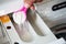 Close Up Of Man Putting Detergent Into Washing Machine