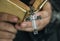 Close up of a man reading a bible with cross hanging religion and belief concept