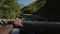 Close up of man riding in blue off road jeep among mountains