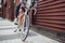 Close Up Of Man Riding Sustainable Bamboo Bicycle On City Street