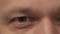 Close-up of man`s eyes, the reflection of the monitor, camera movement