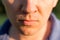 Close Up Of Man& x27;s Face Lips. Portrait of a young man on nature background. Emotion facial expression.