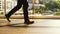 Close up of man`s feet walk on pedestrian crossing on a busy day in the center of the city on a sunny day on the road on