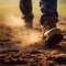 Close-up of man\\\'s feet wear boots walking on the ground in the field. Closeup shot. Brown soil. Low angle view. AI generated