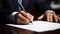 Close-up of a man\\\'s hand in black suit writing with black pen on official document