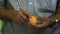 Close up of man\'s hand chopping an Marian plum