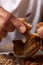 Close-up of man`s hand eating fried pork rinds. Colombian traditional food