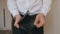 Close-up of a man`s hand holding Leather Wallet Empty with No Money. The concept of poverty. Businessman in white shirt