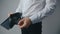 Close-up of a man`s hand holding Leather Wallet Empty with No Money. The concept of poverty. Businessman in white shirt