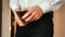 Close-up of a man`s hand holding Leather Wallet Empty with No Money. The concept of poverty. Businessman in white shirt