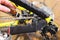Close-up of a man`s hand, led by masters, lubricate the bicycle chain of a mountain bike with a special lubricant in the