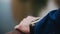 Close-up of a man`s hand with a mechanical clock on it