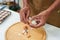 Close-up of a man\\\'s hand peeling a hard-boiled egg to prepare the salad and sandwiches for breakfast. Before going to work