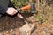 Close-up Man`s Hands Cut Wooden Stick With An Ax