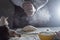 Close-up of a man`s hands kneading dough to make homemade noodles