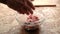 Close-up of man`s hands make cutlets of minced meat. Transparent plate on the kitchen table.