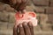 Close up of a man\'s hands opening a pink wireless buds