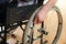 Close Up Of Man\'s Hands Pushing Wheelchair