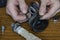 Close-up of a man`s hands showing a torn rubber gasket for a water heater