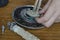 Close-up of a man`s hands showing a torn rubber gasket for a water heater