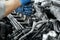 Close up of man`s hands tighten bolts in spark plugs