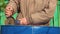 Close-up of a man's hands using a grinder to cut the bottom out of a barrel.