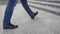 Close up of man`s leather shoes while walking up the stairs. Stock. Businessman goes to the office