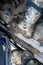 Close-up of a man`s legs in military camouflage with trekking boots soiled in mud in the car