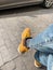 Close up of man\'s legs waiting seated on the bench along the road